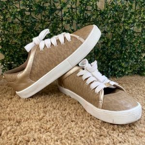 Michael Kors shoes are used, gold color with white they are number 3.